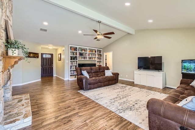 living area featuring lofted ceiling with beams, baseboards, visible vents, and wood finished floors