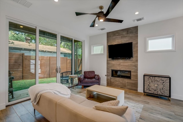 living area with a fireplace, visible vents, and recessed lighting