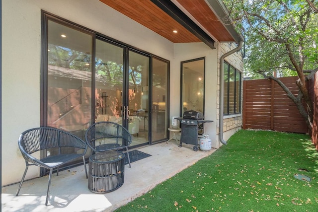 view of patio featuring fence and area for grilling