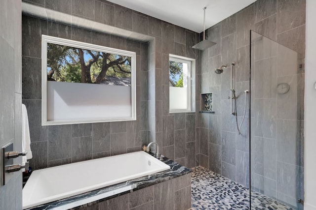 full bath featuring a bath and tiled shower