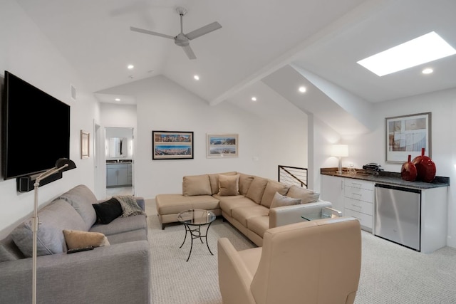 living area with recessed lighting, vaulted ceiling with skylight, a ceiling fan, and light colored carpet