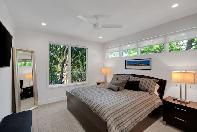 carpeted bedroom featuring a ceiling fan, recessed lighting, and baseboards