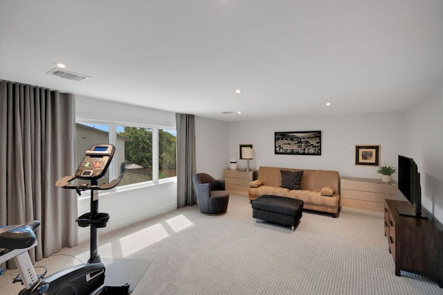 living area with carpet flooring, visible vents, and recessed lighting