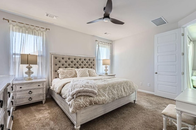 bedroom featuring visible vents, baseboards, and dark carpet