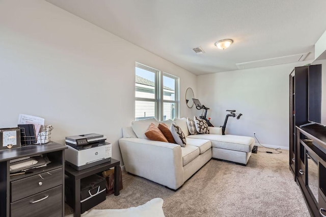 living room with baseboards, visible vents, attic access, and carpet