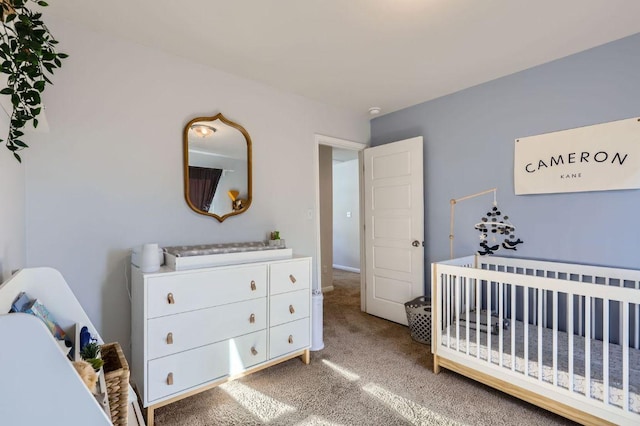 bedroom with a nursery area and light colored carpet