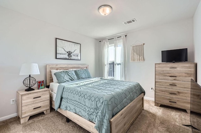 carpeted bedroom with baseboards and visible vents