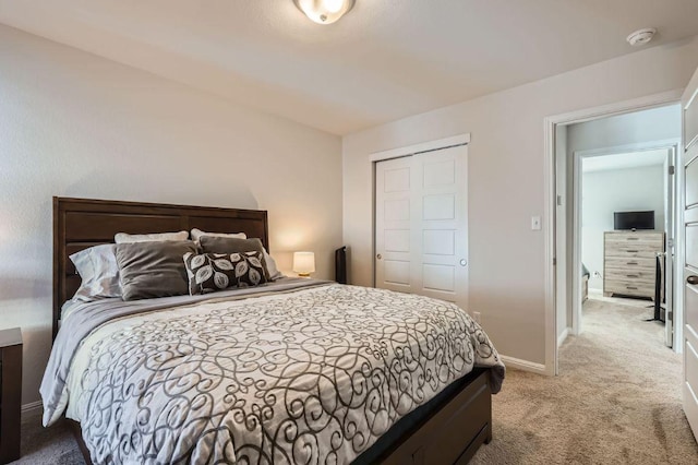 bedroom with carpet, baseboards, and a closet