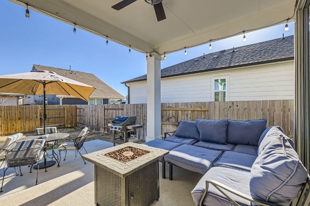 view of patio with an outdoor living space with a fire pit, fence, outdoor dining area, a grill, and a ceiling fan