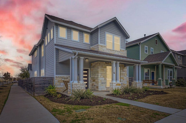 view of front of house with a porch and stone siding