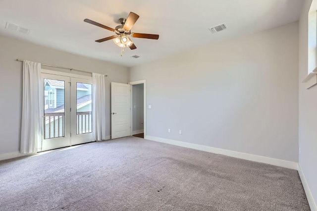 unfurnished room featuring light carpet, visible vents, baseboards, and ceiling fan