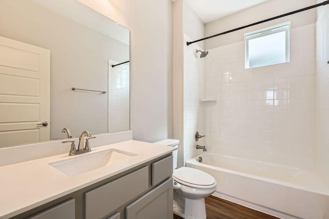 bathroom featuring tub / shower combination, vanity, toilet, and wood finished floors