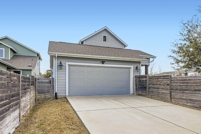 view of front facade featuring concrete driveway, roof with shingles, and fence