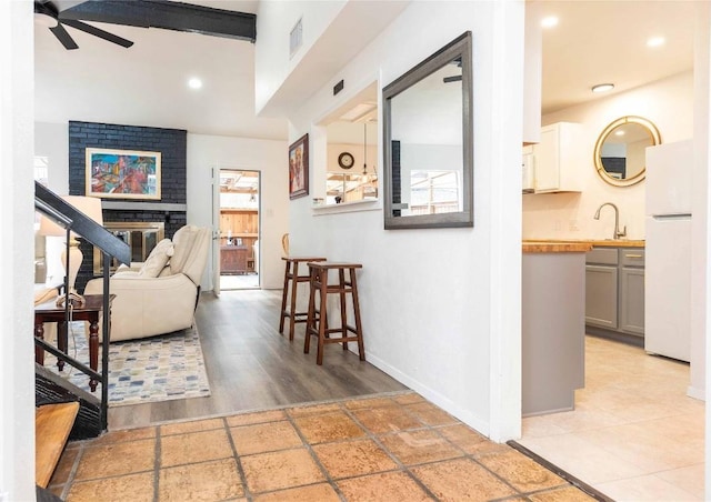 interior space featuring recessed lighting, a fireplace, visible vents, baseboards, and a ceiling fan