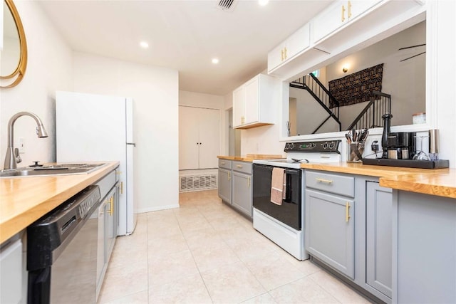 kitchen with white electric stove, butcher block countertops, gray cabinetry, and dishwasher