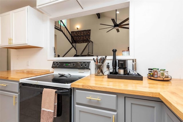 kitchen featuring ceiling fan, wooden counters, electric range, and gray cabinetry