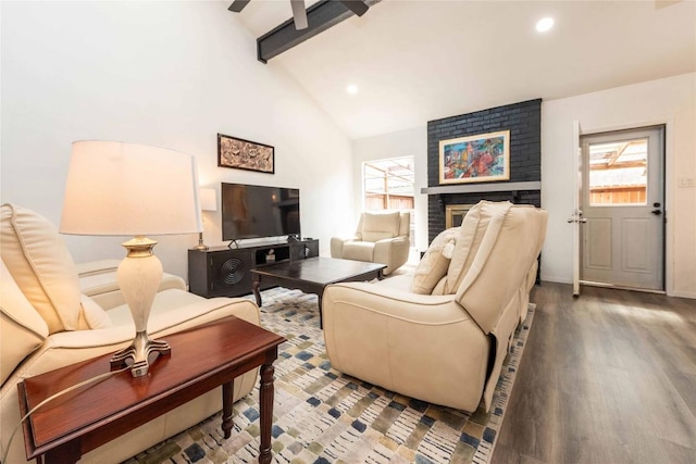 living area with beamed ceiling, a brick fireplace, wood finished floors, and recessed lighting