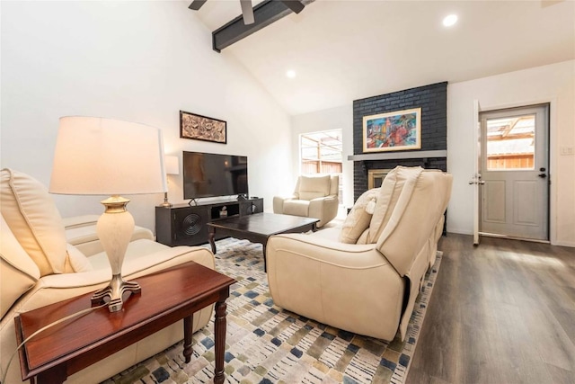 7215 Coronado Cir, Austin, TX 78752 - living room with plenty of natural light, beam ceiling, wood finished floors, a brick fireplace, and recessed lighting