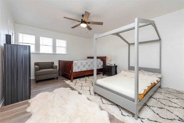 bedroom featuring a ceiling fan and wood finished floors