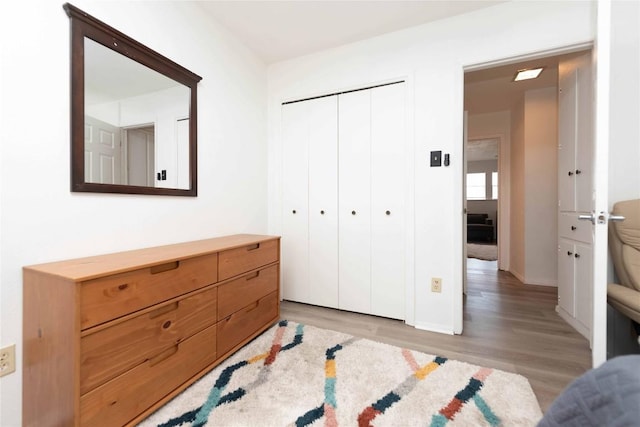 bedroom with a closet and light wood finished floors