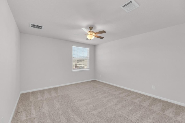 empty room featuring a ceiling fan, carpet, visible vents, and baseboards