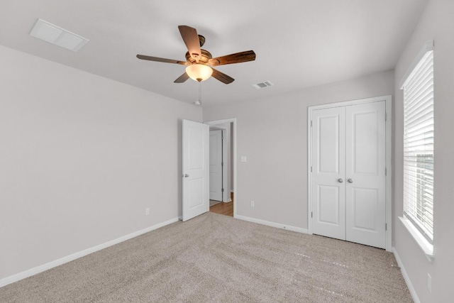 unfurnished bedroom featuring visible vents, baseboards, a ceiling fan, carpet, and a closet