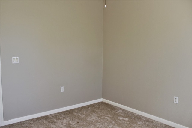 unfurnished room with carpet floors and baseboards