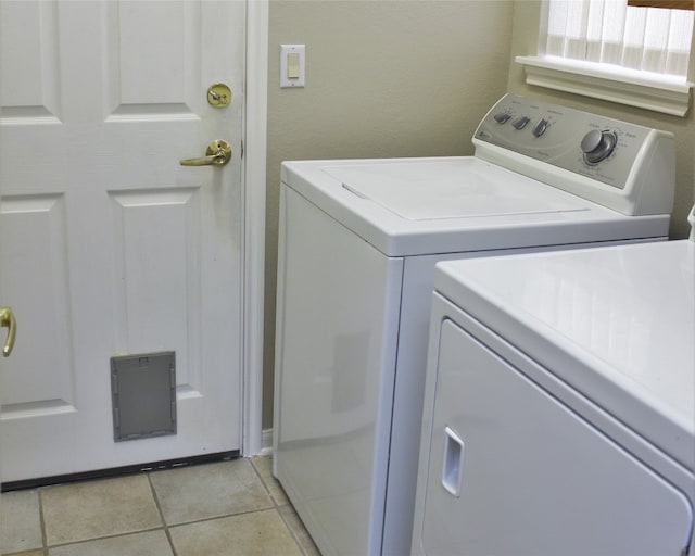 laundry area with light tile patterned floors, laundry area, and washer and dryer