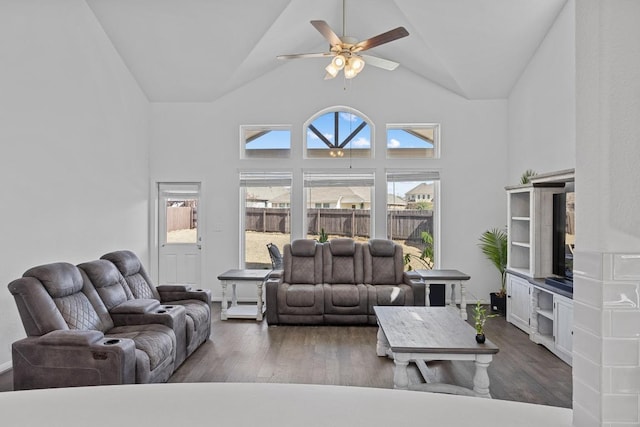 living room featuring ceiling fan, high vaulted ceiling, and wood finished floors