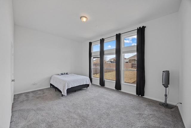 bedroom featuring carpet and baseboards