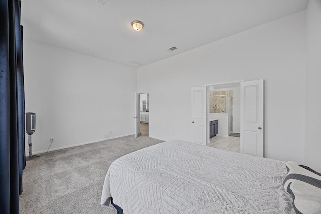 bedroom with visible vents, light carpet, and baseboards