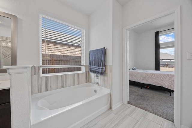 full bathroom featuring vanity, ensuite bath, and a bath