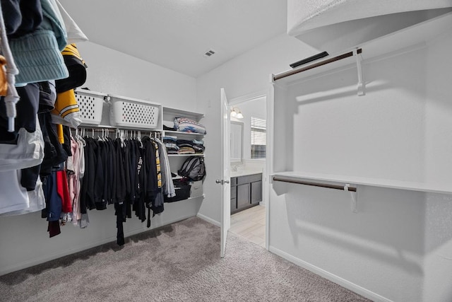 walk in closet featuring carpet and visible vents