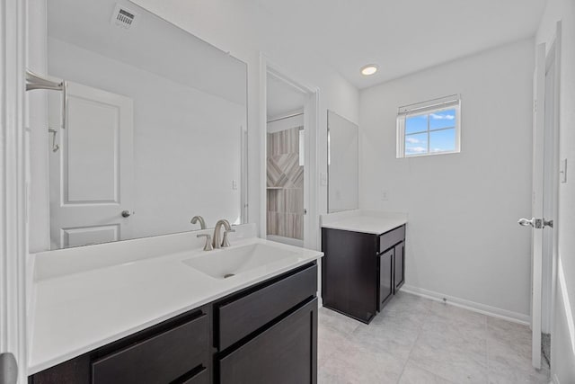 bathroom featuring baseboards, visible vents, tile patterned flooring, and vanity