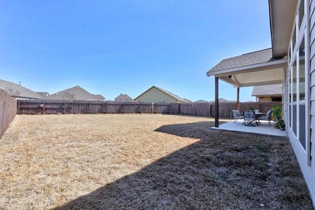 view of yard featuring a patio area and a fenced backyard