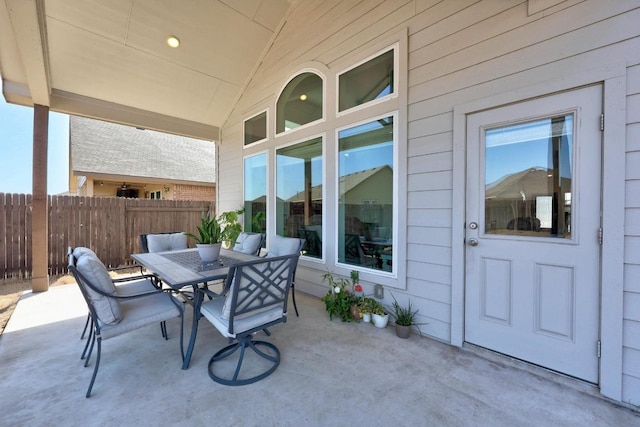 view of patio with fence and outdoor dining space