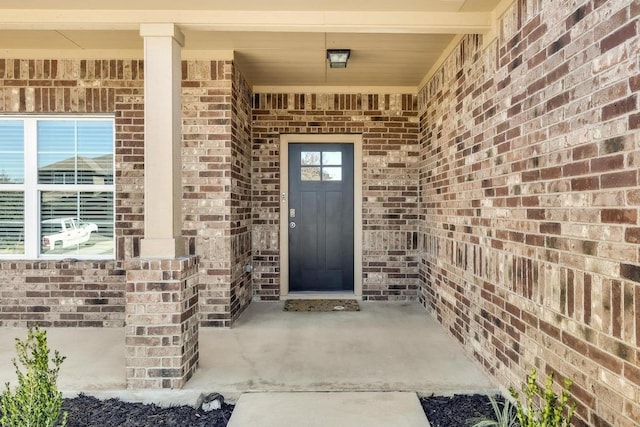 property entrance featuring brick siding