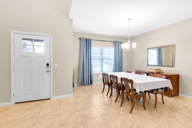 dining room featuring light tile patterned floors, baseboards, and a notable chandelier