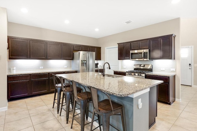 kitchen featuring a sink, light tile patterned flooring, visible vents, and stainless steel appliances