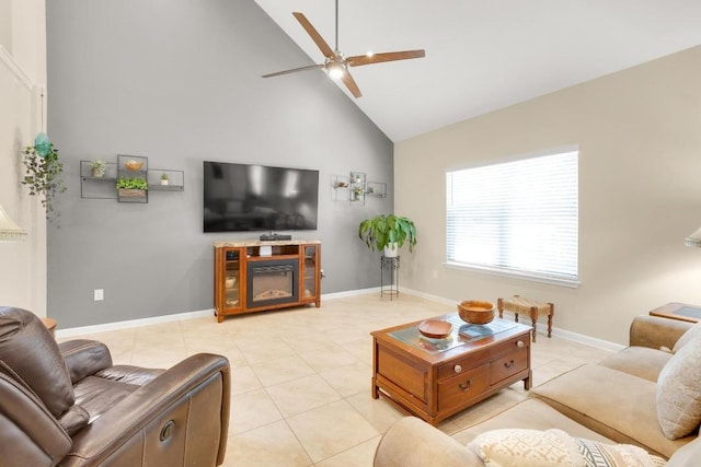 living area featuring light tile patterned floors, high vaulted ceiling, baseboards, and a ceiling fan