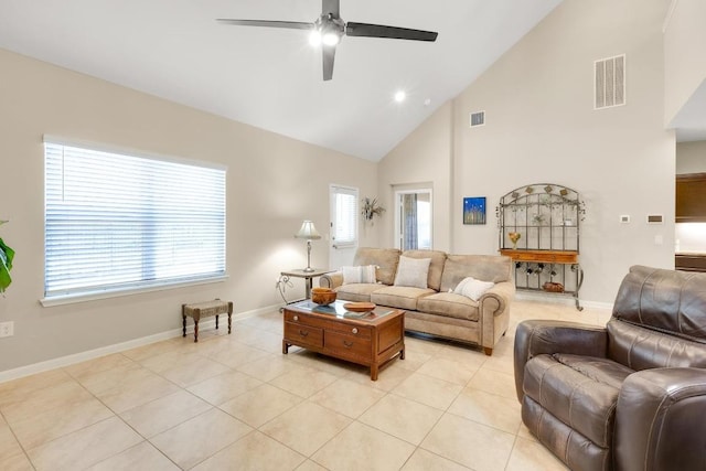 living room with light tile patterned floors, visible vents, and baseboards