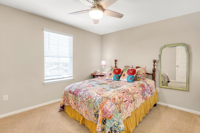 bedroom with baseboards, light colored carpet, and a ceiling fan