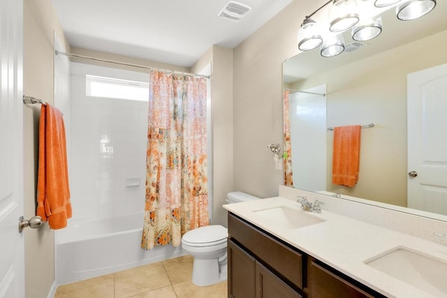 bathroom with a sink, visible vents, toilet, and tile patterned flooring