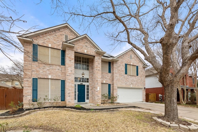 traditional-style home with a garage, driveway, brick siding, and fence