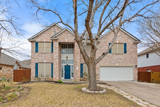 traditional-style home with driveway, an attached garage, fence, a front lawn, and brick siding