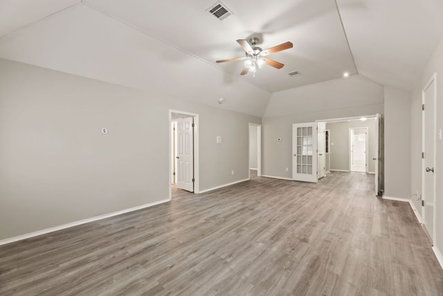 unfurnished living room featuring baseboards, visible vents, lofted ceiling, ceiling fan, and wood finished floors