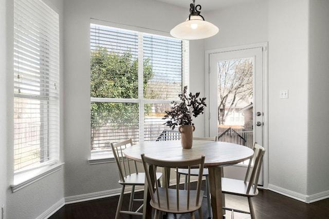 dining area with dark wood finished floors and baseboards