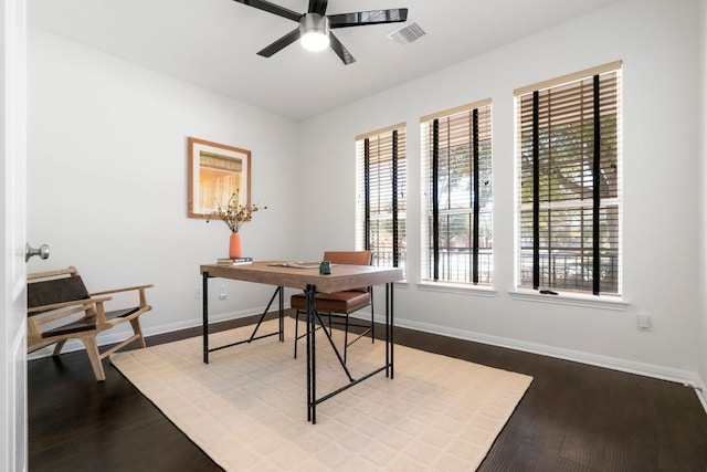 office featuring ceiling fan, visible vents, baseboards, and wood finished floors