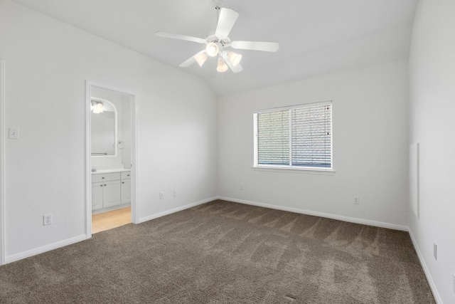 carpeted spare room with baseboards, lofted ceiling, and a ceiling fan