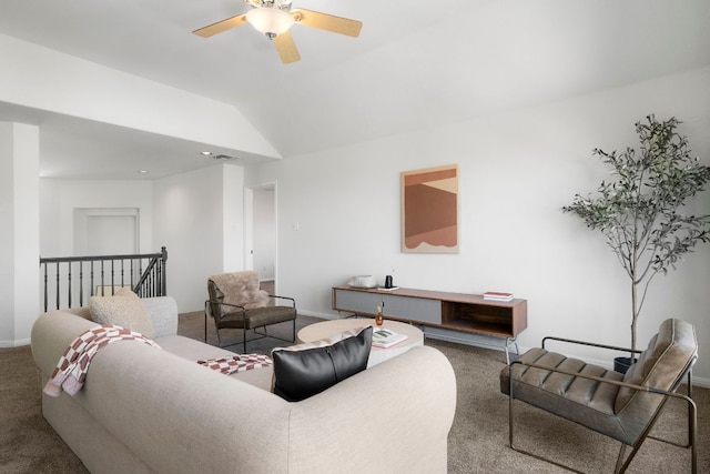 living area with vaulted ceiling, ceiling fan, baseboards, and carpet floors